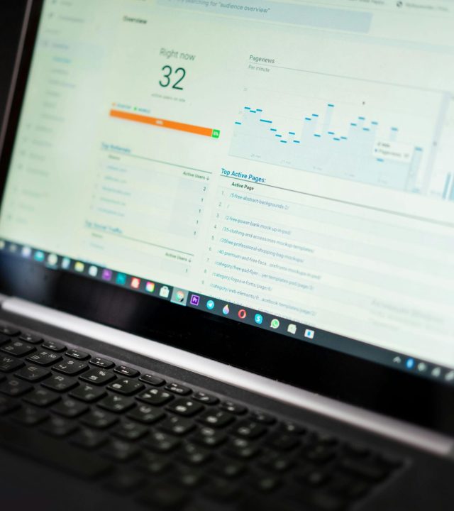 A laptop displaying an analytics dashboard with real-time data tracking and analysis tools.